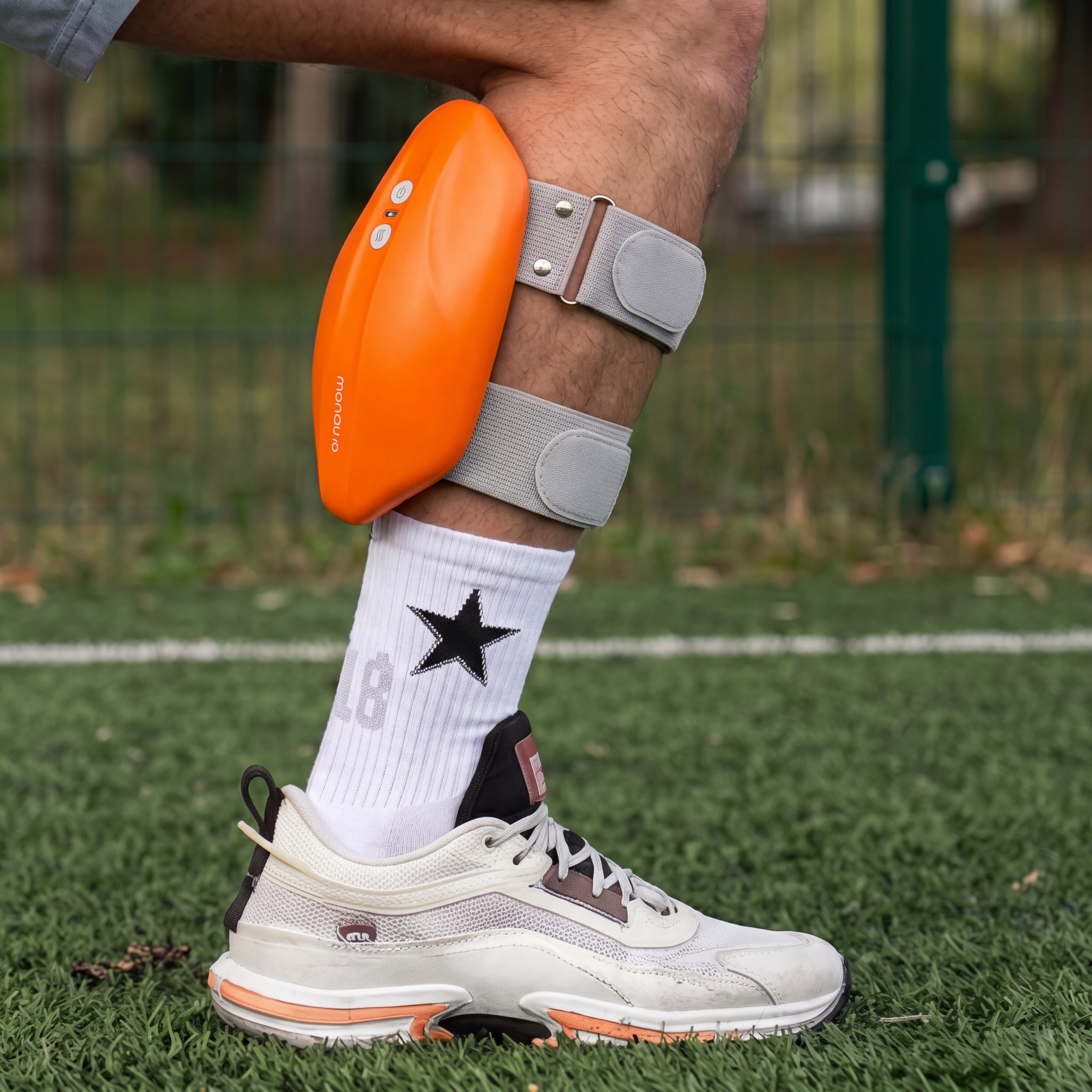 Orange MONAURO RecoveryAir Calf Pro secured around a rider's lower leg